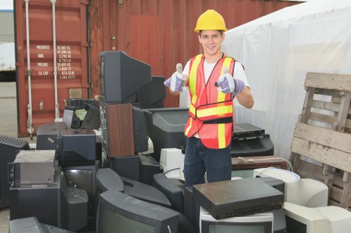 Residents disposing of furniture at a recycling center in Sanderstead